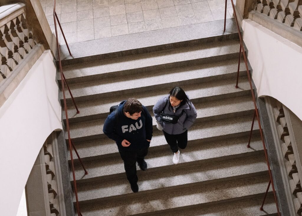 Bild zweier Sudierender auf der Treppe im Kollegienhaus